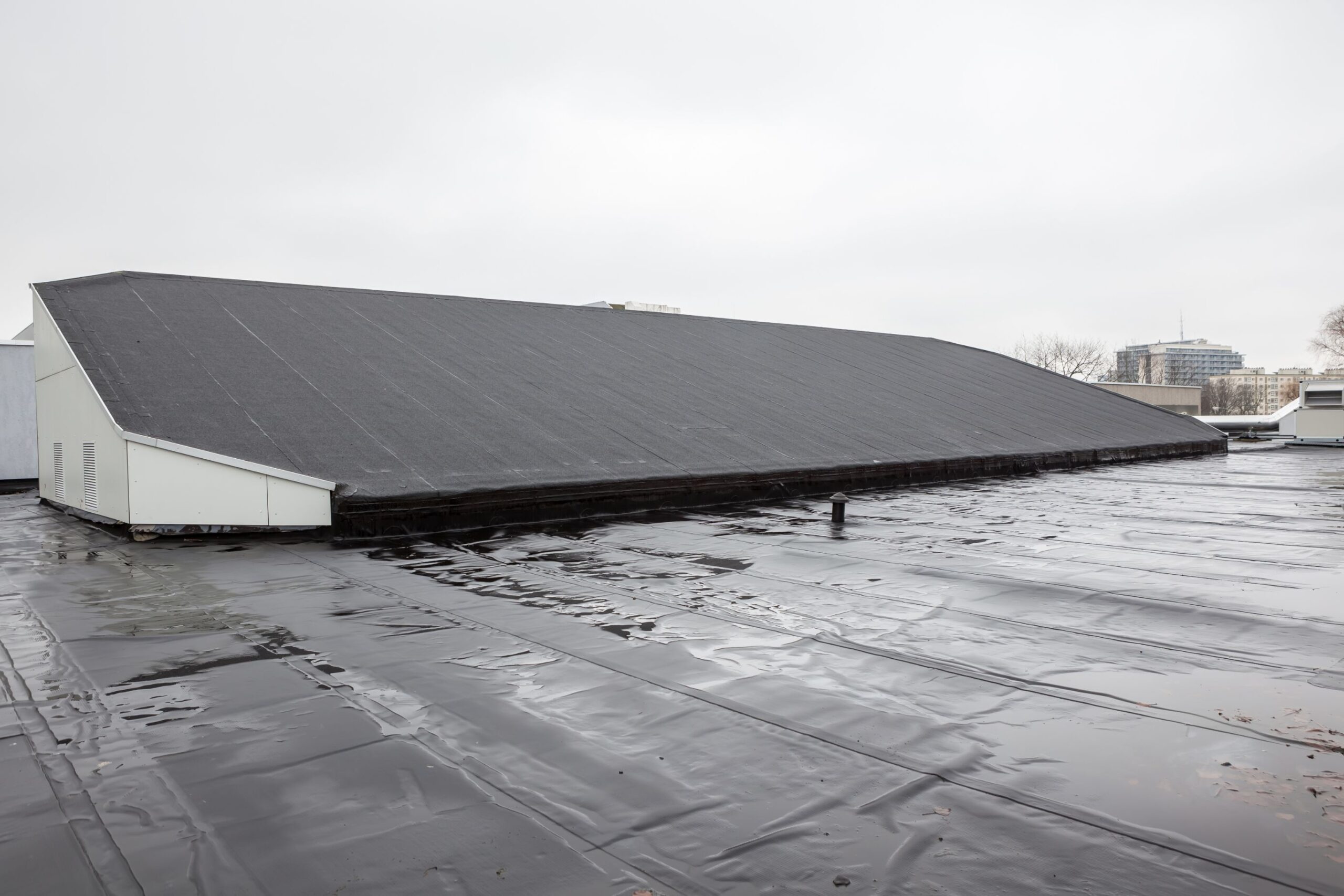EPDM rubber roof being installed on a commercial building in Katy, Texas