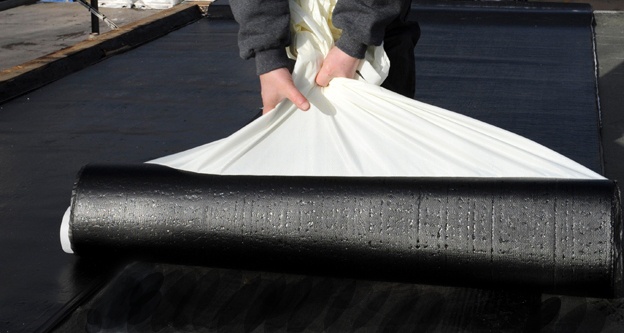 self-adhesive roll roofing installed on residential flat roof Katy TX