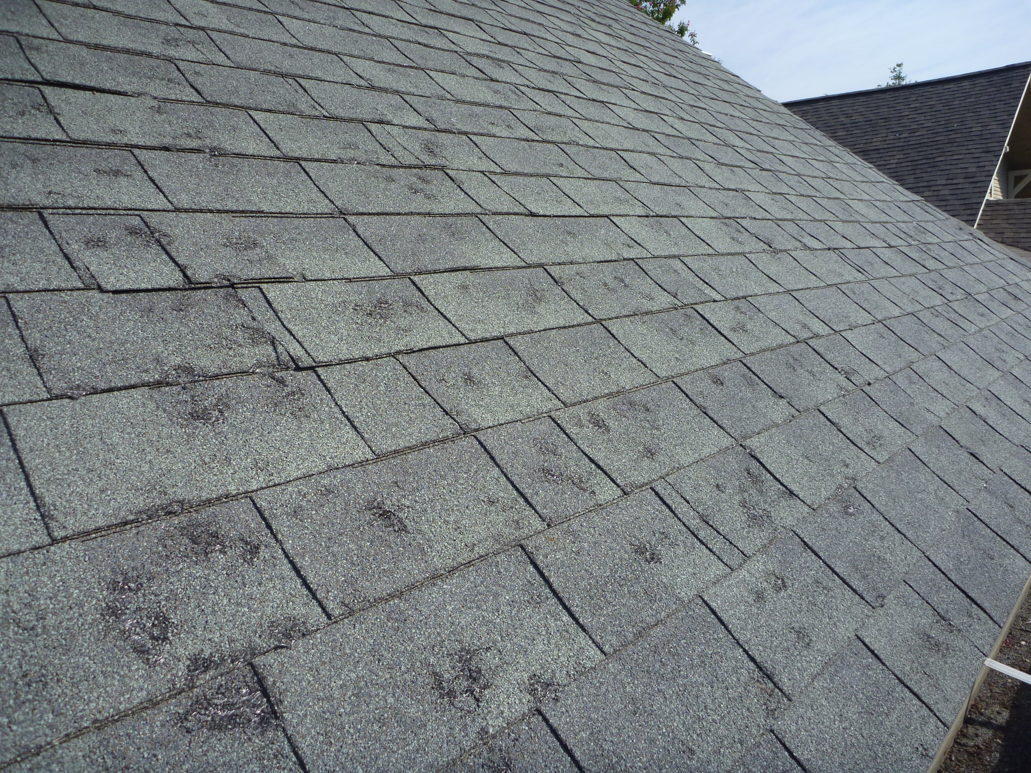 Storm damage roof requiring emergency repair in Katy, Texas